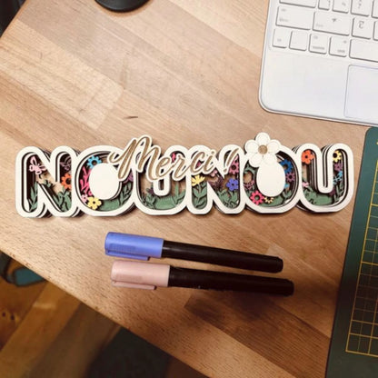 L'Atelier de Lylou, décoration en bois multicouches "Merci Nounou" avec motif floral et papillons.
